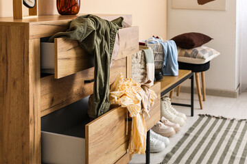 Chest of drawers with clothes in dressing room