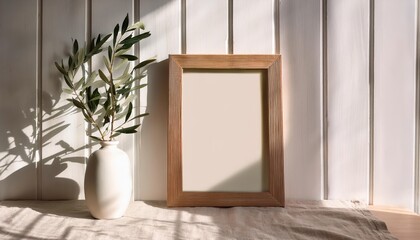 Sunlit Wooden Frame Empty Canvas with Modern Organic Vase and Olive Branch, Capturing a Fresh and Elegant Scene in Natural Light