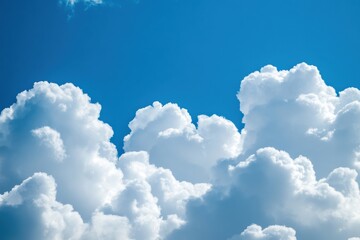Naklejka premium Fluffy white clouds floating against a bright blue sky for nature lovers seeking tranquil and picturesque scenery in their photography collections