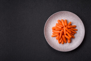 Raw peeled mini baby carrots as an ingredient for preparing a vegetarian food