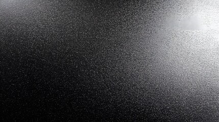 Gritty metallic powder coated surface with a dark rough texture and subtle sheen creating a modern and industrial inspired background perfect for design applications digital art and creative projects
