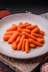 Raw peeled mini baby carrots as an ingredient for preparing a vegetarian food
