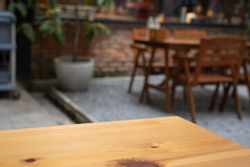 Background cafe wood counter blur effect, dark yet cozy ambiance in the restaurant, Table in kitchen, drink wooden desk bokeh light, abstract design for a modern space.