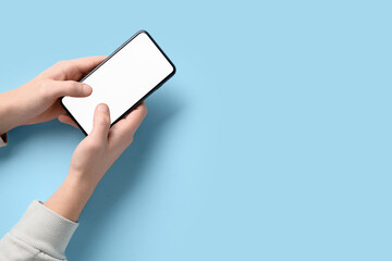 Man using mobile phone on blue background. Survey concept