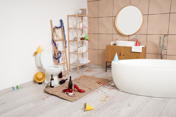 Interior of messy restroom after party with toilet bowl and decorations