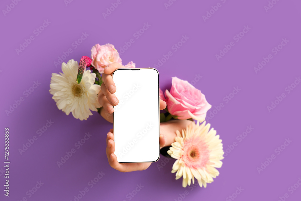 Canvas Prints Female hands with modern mobile phone and flowers visible through hole in purple teared paper