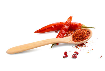 Wooden spoon with red chili flakes and peppers on white background