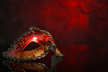 Beautiful carnival mask on dark red background