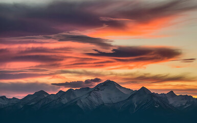 Serene Sunset Over Mountains with Vibrant Cloud Reflections.