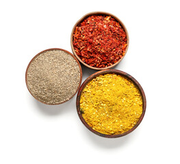 Wooden bowls with aromatic spices isolated on white background