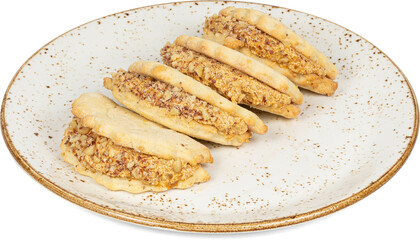 A white plate with sandwiches elegantly topped with nuts