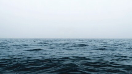 Obraz premium Serene Calm Ocean View with Gentle Waves and Foggy Horizon