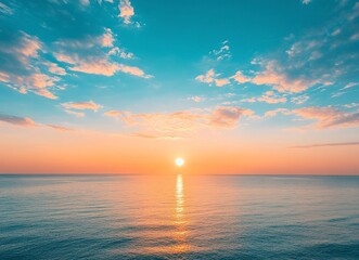Beautiful sunrise over the sea, blue sky with clouds and sun on the horizon, peaceful nature background. Calm seascape view with copy space for text. Stock photo, empty copy area.