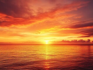 Fototapeta premium Beautiful sunset over the sea with an orange sky and golden clouds. A beautiful view of the natural landscape with copy space on the right side. The sun sets in a tropical island background.