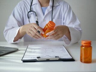 A close-up of a female doctor explaining the instructions for the medication to a patient during...