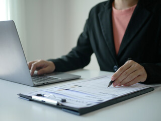 Young businesswoman holds a resume and evaluates it. Views the personal history of job applicants. Recruitment concept