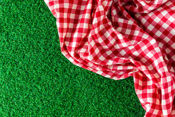 red tablecloth on green background