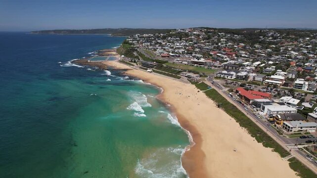 Merewether Beach With Ocean Baths On Shoreline Of New South Wales In Australia. aerial descend