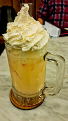 Refreshing drink of iced chocolate milk with ice cream topping