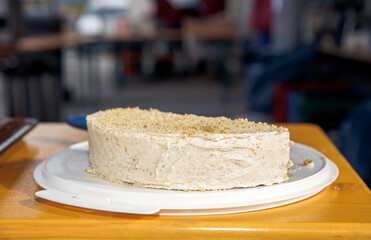 Homemade vanilla cake with crumb topping on white plate in kitchen setting