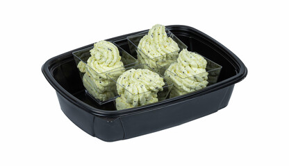 A black container filled with various foods on a white background