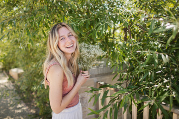 Young Woman holding a bouquet at a park