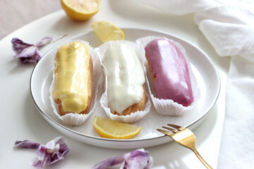Three eclairs with different fillings lie in a plate