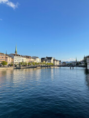 Serene Historical Waterfront in Lucerne with Church Spires and Calm Waters
