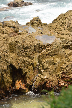 Rocks in the sea of ​​tropical beaches in Oaxaca, Mexico
