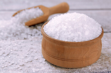Sea salt on a wooden table. Coarse sea salt for cooking.