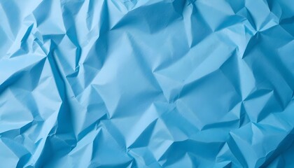 Textured blue crumpled paper background with intricate details, offering a clean area for copy or graphic content