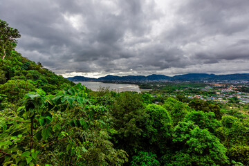 Obraz premium Nature background of the seaside forest, mangrove forest with large mountains surrounding, clear sky and cool breeze during adventure travel.