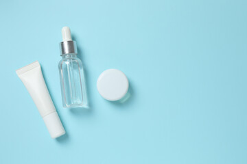 Natural cosmetic products on a blue background, top view
