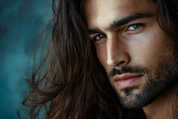 Portrait of young attractive man with beard and long dark hair