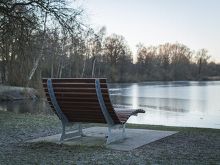 Cozy bench in the morning by the lake in sub-zero temperatures