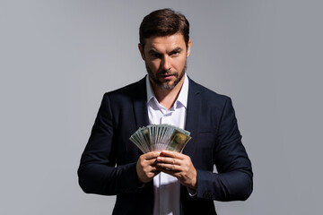 Man with money cash. Dollar banknotes. Portrait of man holding bunch of money banknotes. Dollar...