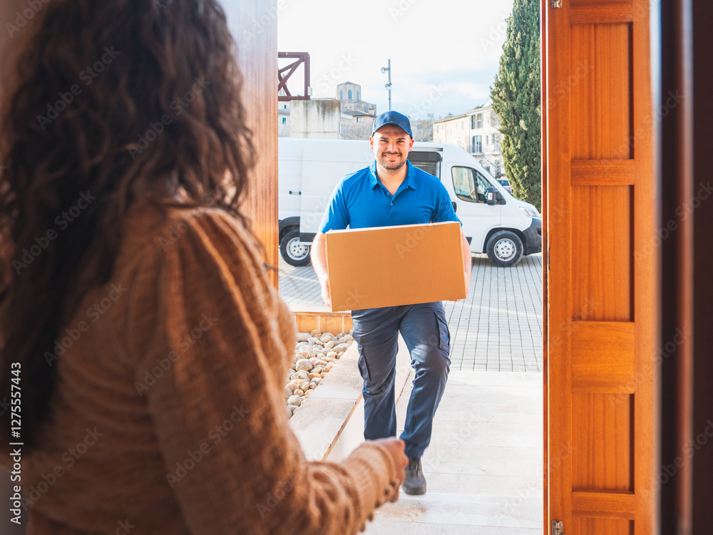 Poster smiling delivery driver handing package at home doorstep. delivery driver concept in a van. man in b