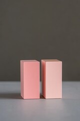 Two pink blocks on gray surface, minimalist still life