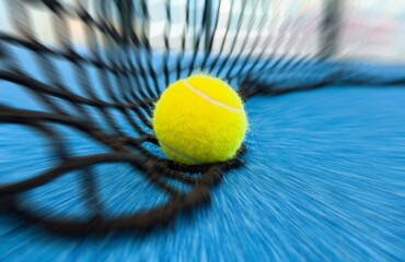 balls near the net of a blue paddle tennis court, sports courts