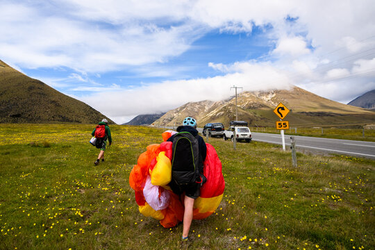 Friends hike and fly paragliding adventure in New Zealand mountains