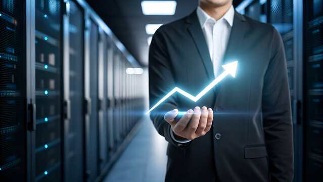 entrepreneurship tips startup scalability resilience A businessman showcases a glowing growth chart in a data center, symbolizing progress and technology.