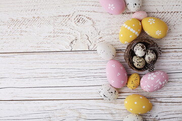 Easter decoration with colorful easter eggs on rustic white wooden background