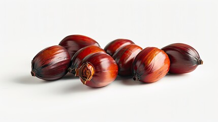 Obraz premium Palm oil nuts displayed in a dynamic cluster on a clean white background showcasing rich red and brown tones with varied surface textures.