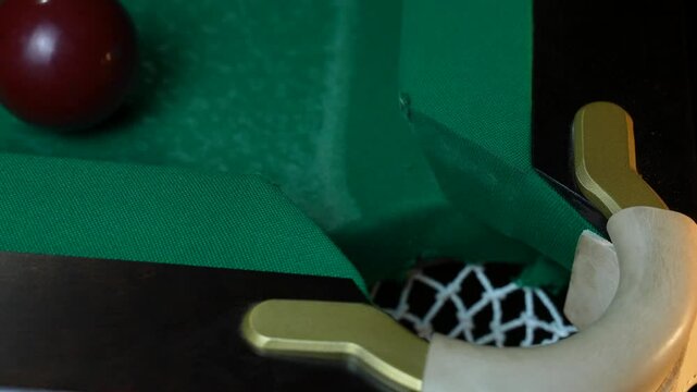 Young man playing American billiard pool poule close-up. Colorful balls on green billiards table .Billiard balls with numbers on a pool table. Billiards team sport.