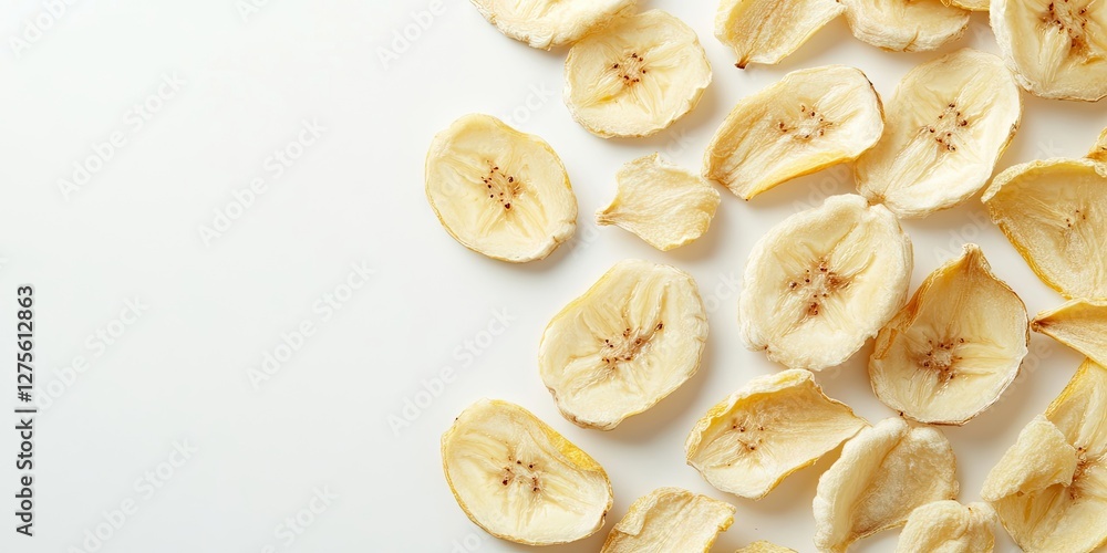 Poster dried banana slices arranged on a clean white surface showcasing their light yellow color and distin