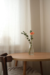 A stylish dining table with a charming floral arrangement and an inviting teatime.