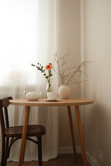 A serene minimalist setup with a wooden table, stylish teapot, and natural decor accents enhancing the ambiance