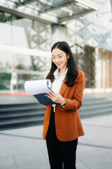 oung Asian business woman leader entrepreneur, professional manager holding digital tablet computer