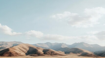 Naklejka premium Rolling Hills Under a Pale Blue Sky