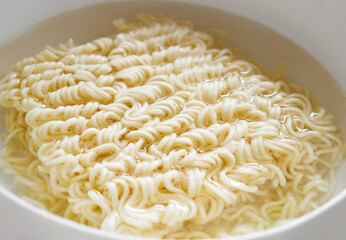 Instant noodles in a bowl. Eating noodle soup. Homemade speed food. Asian dishes.